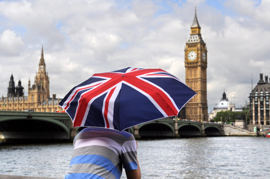 Big Ben and tourist with British flag